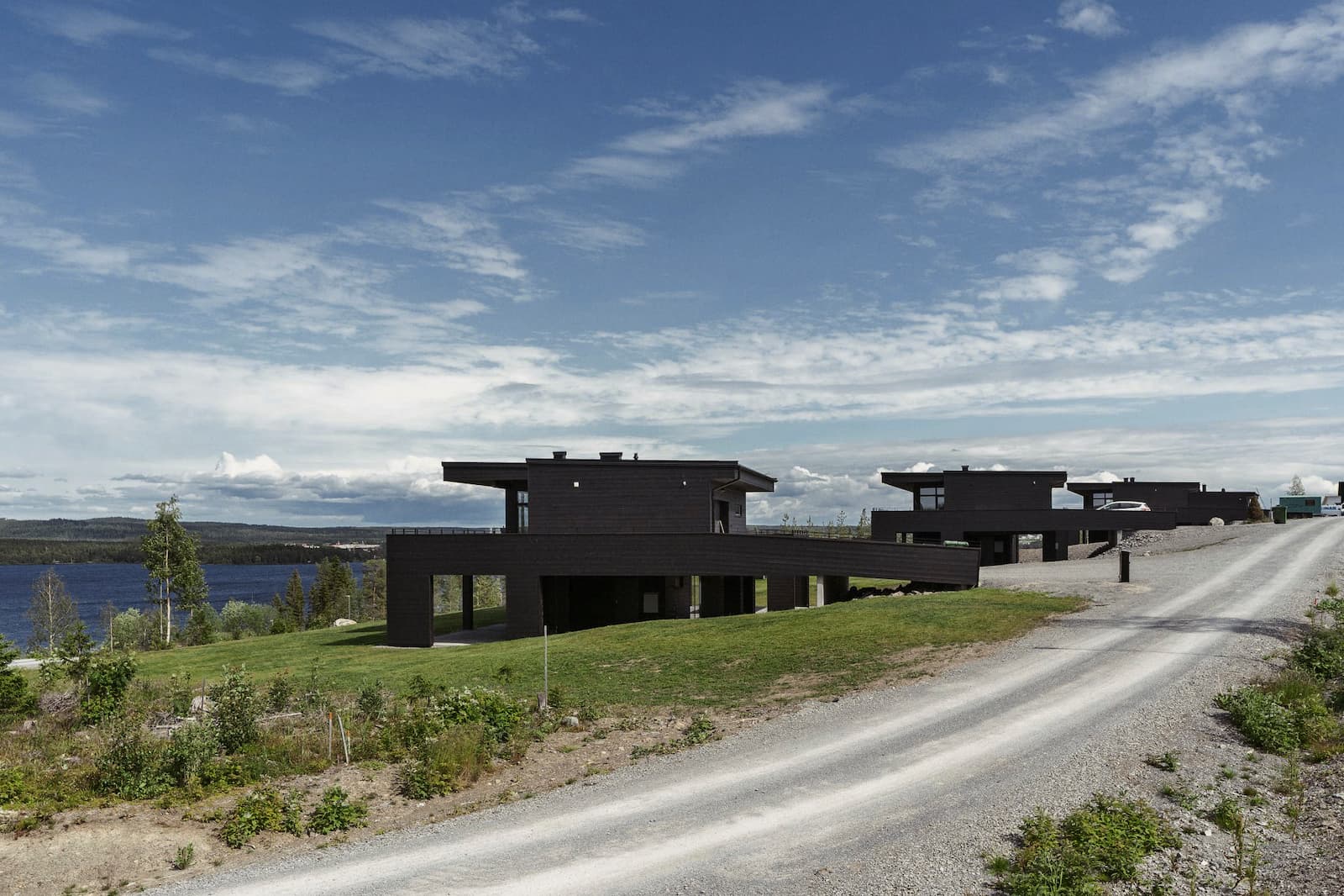 Arkitektoniska svarta hus i sluttning mot sjön Storsjön Östersund
